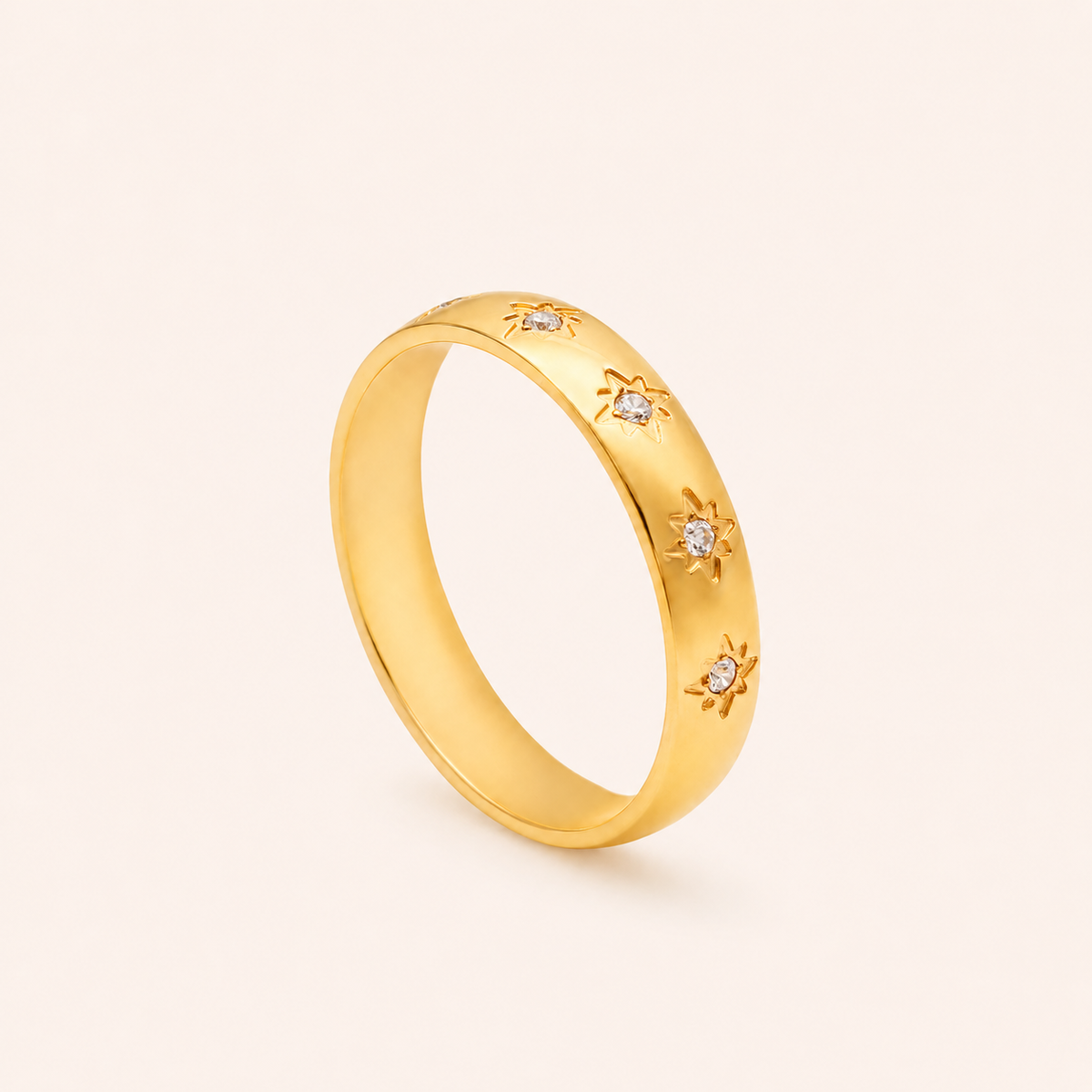 Sol Ring i 18k PVD-guld med solformade detaljer och små zircon på ljus bakgrund.
